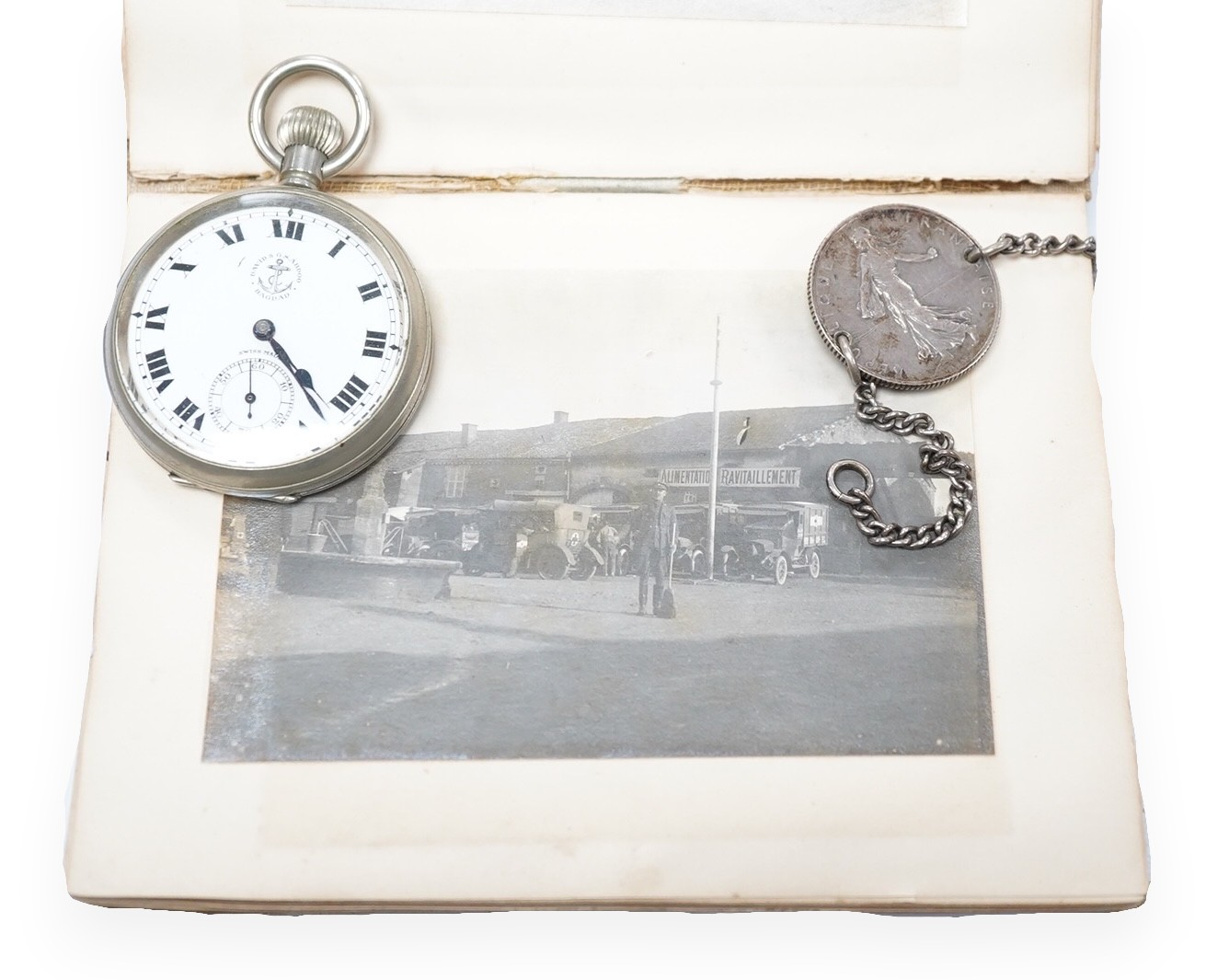 A WWI Ambulance and Balloon Brigade photograph album, pocket watch, coin, etc. Condition - fair, pocket watch ticks when wound